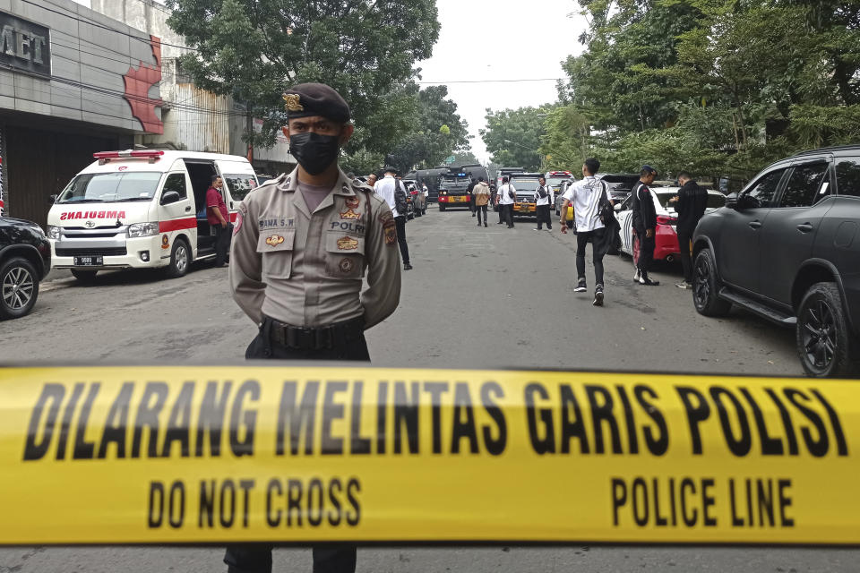 A police officer stands guard on a road leading to the police station where an explosion went off in Bandung, West Java, Indonesia, Wednesday, Dec. 7, 2022. A man blew himself up Wednesday outside a police station on Indonesia’s main island of Java in what appeared to be the latest in a string of suicide attacks in the world’s most populous Muslim nation. (AP Photo/Ahmad Fauzan)