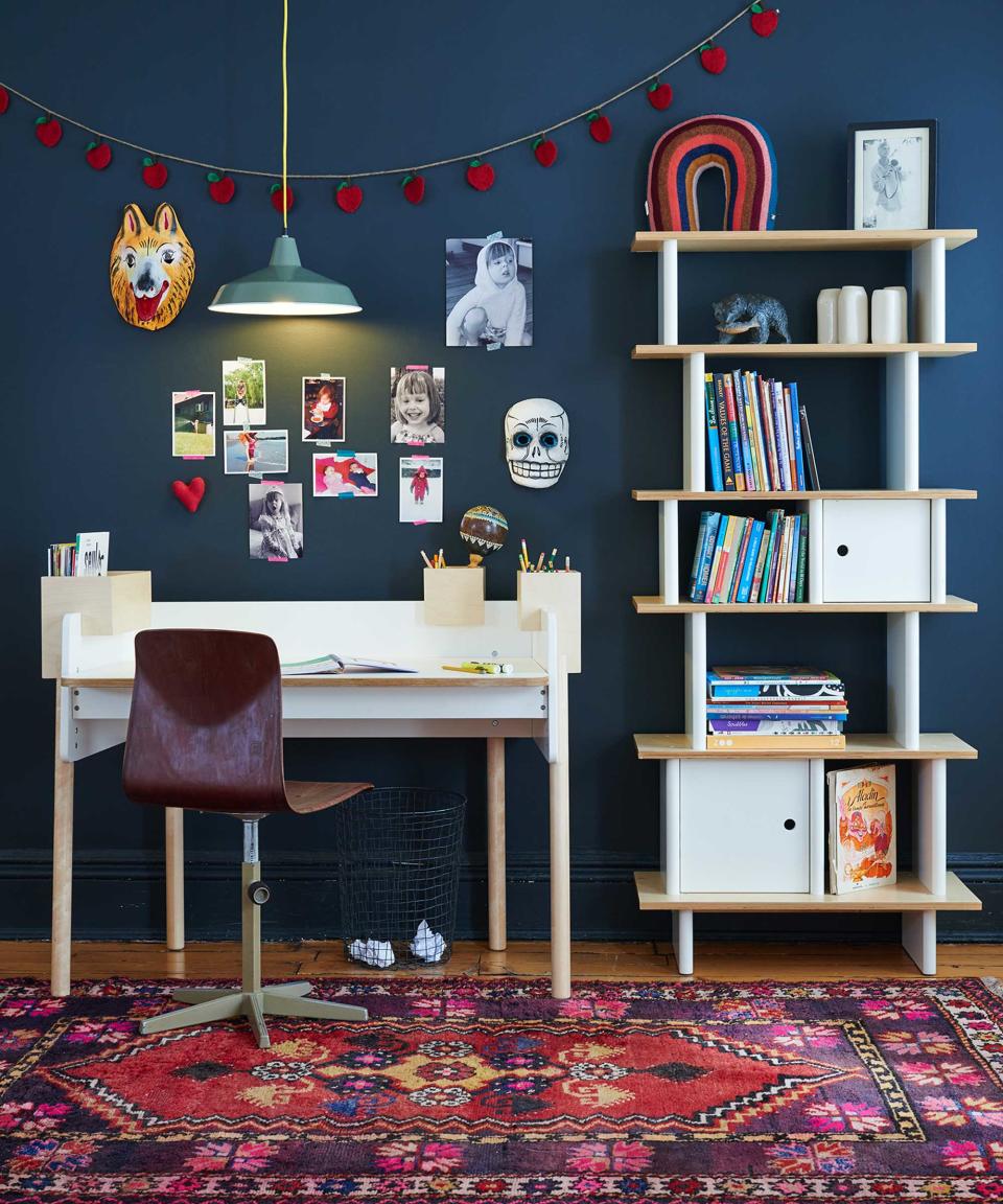 bookshelves and desk in navy blue kids room