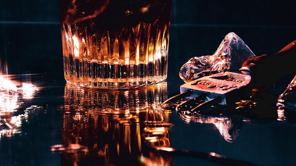 a glass of water with a crystal on top