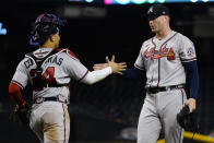 Atlanta Braves relief pitcher Sean Newcomb, right, celebrates with catcher William Contreras after a baseball game against the Arizona Diamondbacks, Wednesday, Sept. 22, 2021, in Phoenix. The Braves won 9-2. (AP Photo/Matt York)