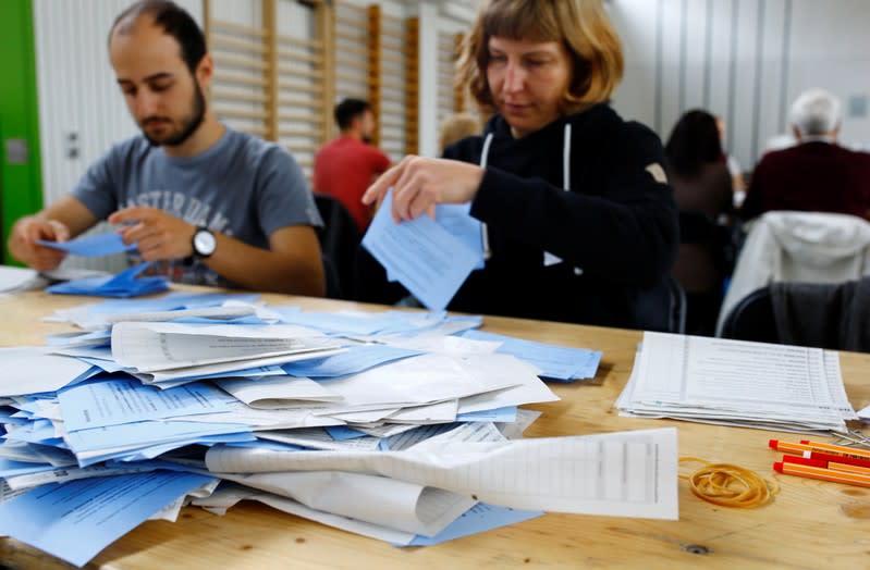 Members of the district election office Stadtkreis 3 sort ballots for the Swiss federal elections in Zurich