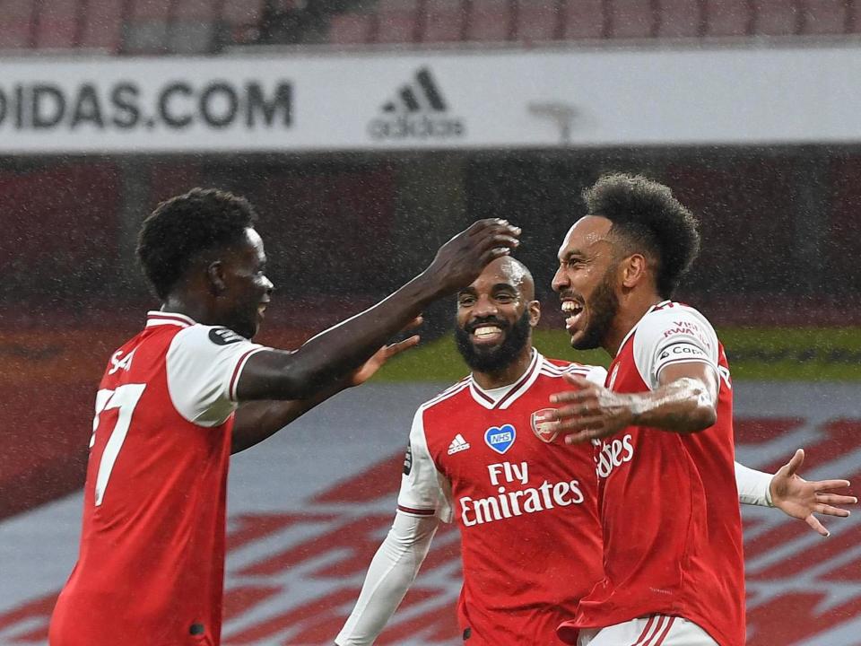 Saka, Lacazette and Aubameyang celebrate: Getty