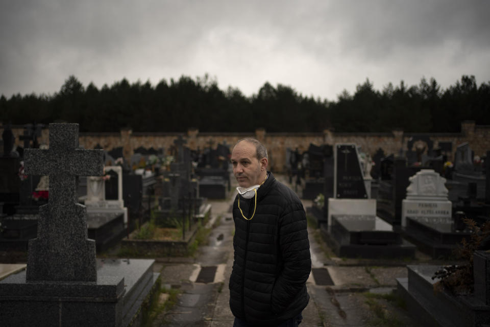 In this April 28, 2020 photo, Mayor Alberto Abad stands in the cemetery in Duruelo de la Sierra, Spain, in the province of Soria. Many in Spain's small and shrinking villages thought their low populations would protect them from the coronavirus pandemic. The opposite appears to have proved true. Soria, a north-central province that's one of the least densely peopled places in Europe, has recorded a shocking death rate. Provincial authorities calculate that at least 500 people have died since the start of the outbreak in April. (AP Photo/Felipe Dana)