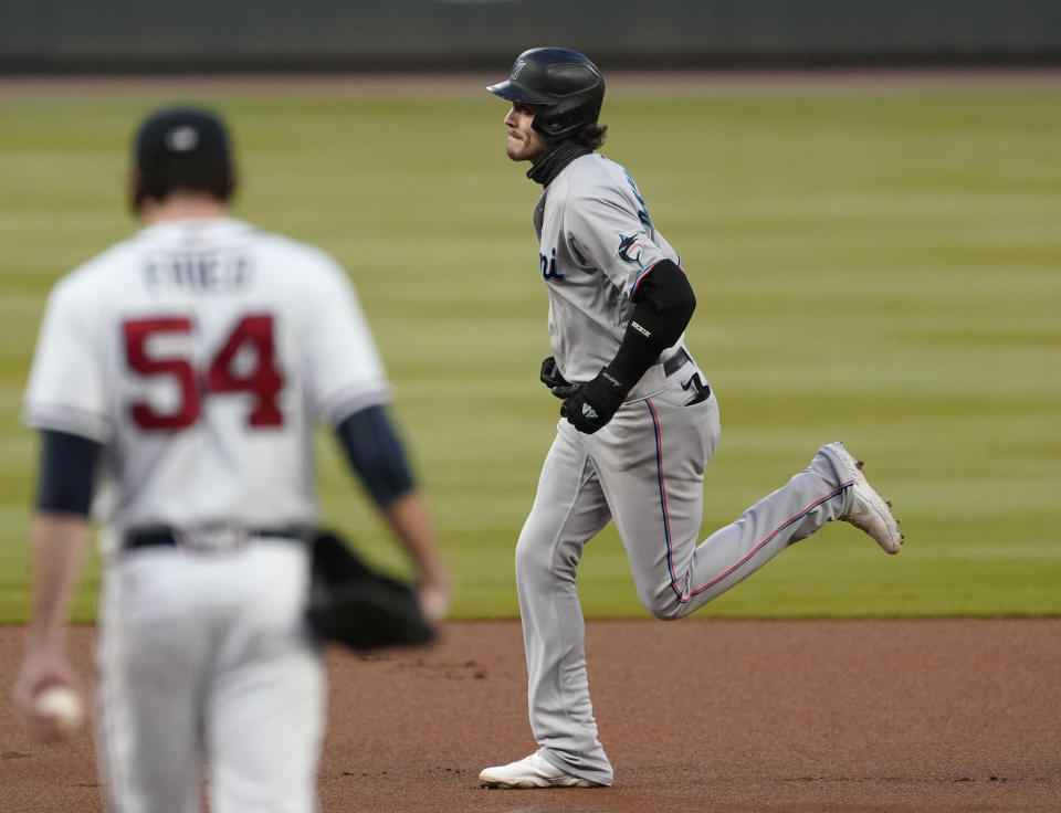 Miami Marlins' Brian Anderson, right, rounds the bases in front of Atlanta Braves starting pitcher Max Fried, left, after hitting a solo home run in the first inning of a baseball game Wednesday, Sept. 23, 2020, in Atlanta. (AP Photo/John Bazemore)