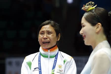 India's bronze medallist Laishram Sarita Devi reacts during the medal ceremony for the women's light (57-60kg) boxing competition at the Seonhak Gymnasium during the 2014 Asian Games in Incheon October 1, 2014. REUTERS/Kim Kyung-Hoon