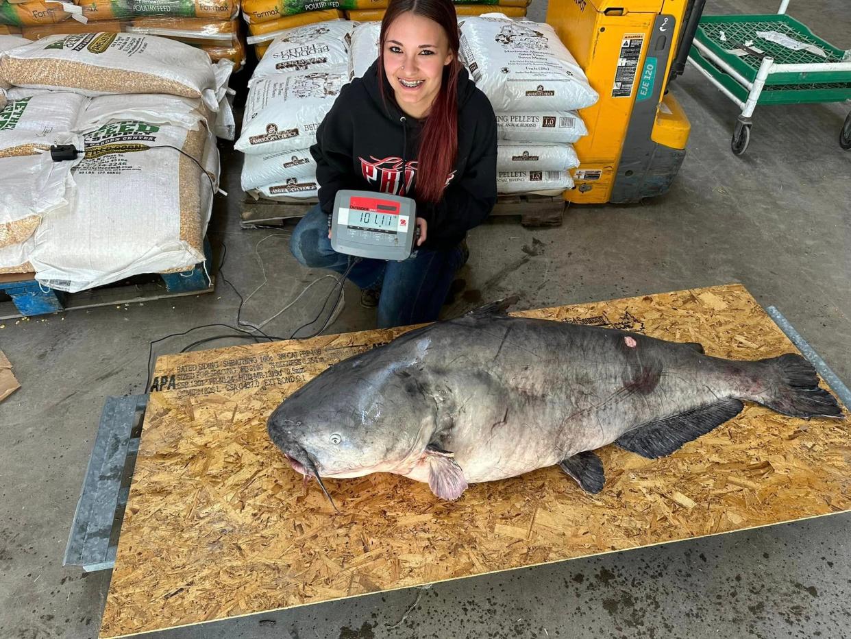 Jaylynn Parker poses with the 101.11 pound catfish she landed on the Ohio River on April 7.