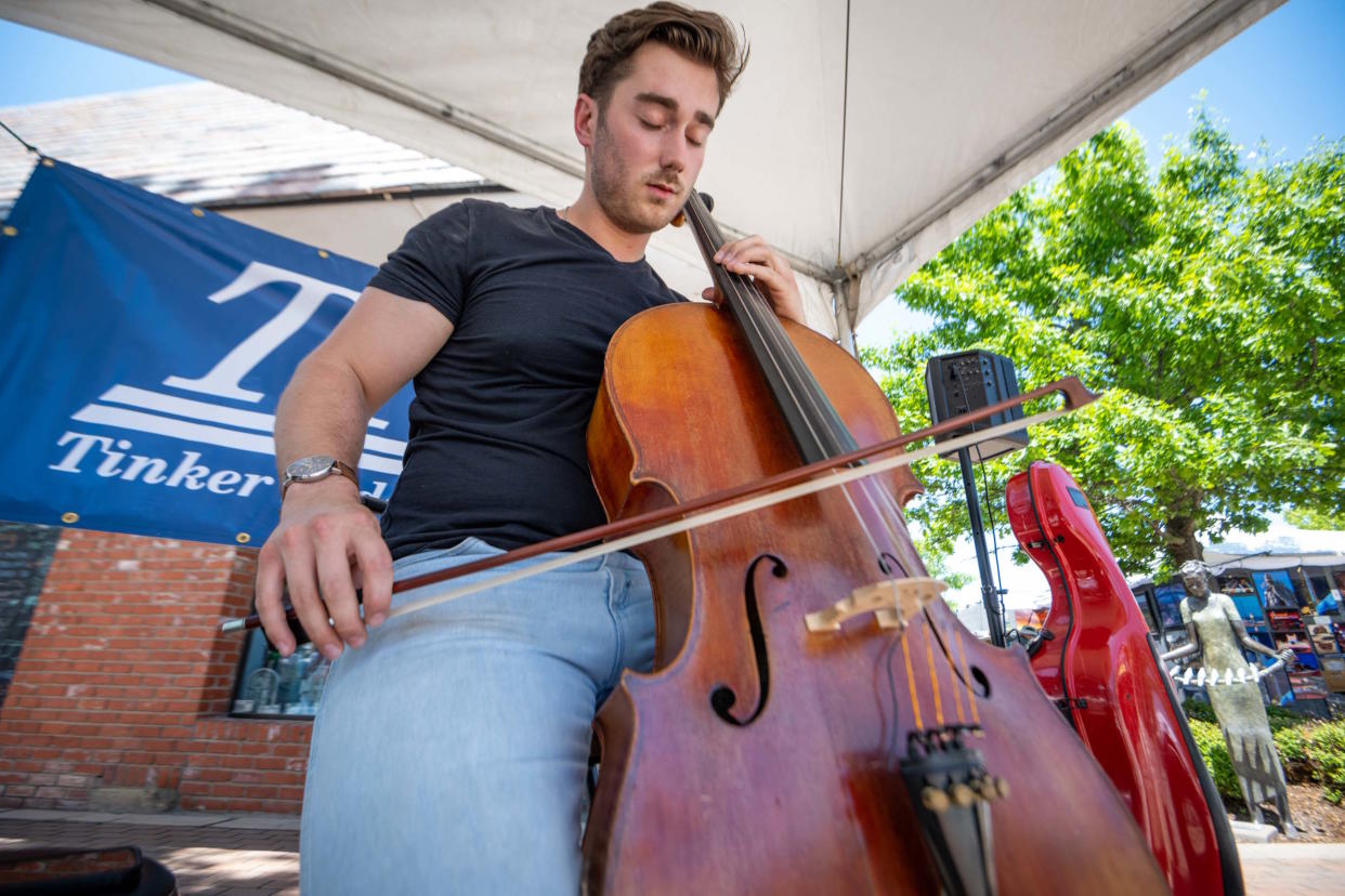 Cellist Sam Kahre performs at the Downtown Edmond Arts Festival.