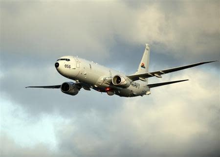 A P-8A Poseidon surveillance plane conducts flyovers above the Enterprise Carrier Strike Group on February 3, 2012 in this handout photo courtesy of the U.S. Navy. REUTERS/U.S. Navy/Mass Communication Specialist 3rd Class Daniel J. Meshel/Handout