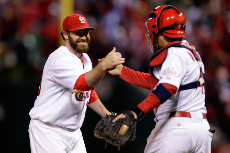 ST LOUIS, MO - OCTOBER 19: Jason Motte #30 and Yadier Molina #4 of the St. Louis Cardinals celebrate after defeating the Texas Rangers 3-2 during Game One of the MLB World Series at Busch Stadium on October 19, 2011 in St Louis, Missouri. (Photo by Rob Carr/Getty Images)