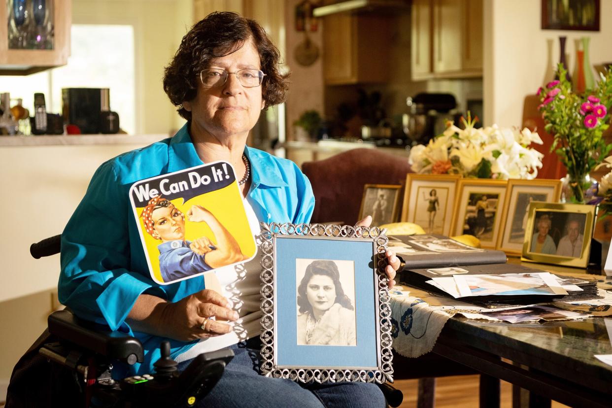 Dorene Giacopini holds up a photo of her mother Primetta Giacopini while posing for a photo at her home in Richmond, Calif. on . Primetta Giacopini's life ended the way it began - in a pandemic. She was two years old when she lost her mother to the Spanish flu in Connecticut in 1918. Giacopini contracted COVID-19 earlier this month. The 105-year-old struggled with the disease for a week before she died Sept. 16 Virus Outbreak Double Pandemic, Richmond, United States - 27 Sep 2021