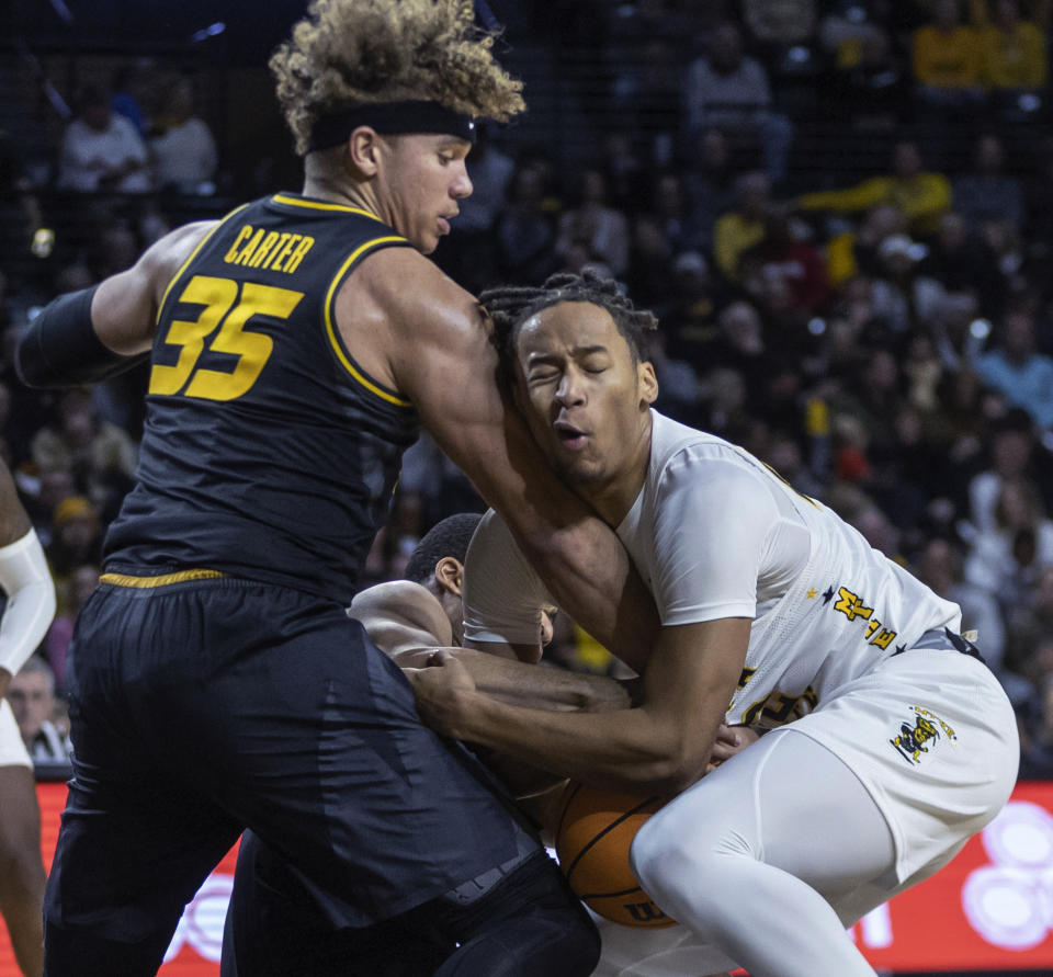 Wichita State's Shaman Scott, right, has the ball as Missouri's Nick Honor, middle, and Noah Carter defend during the first half of an NCAA college basketball game Tuesday, Nov. 29, 2022, in Wichita, Kan. (Travis Heying/The Wichita Eagle via AP)