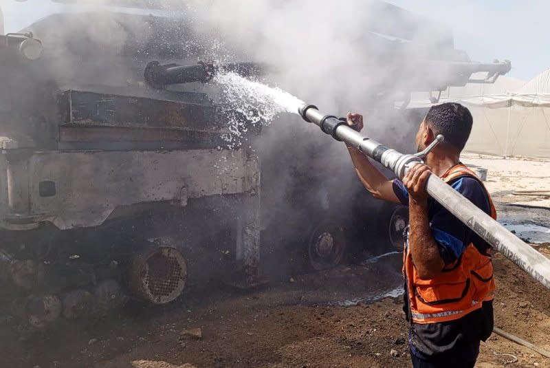 Firefighters put out a fire following a military strike on an area designated for displaced Palestinians near Al-Mawasi in the southern Gaza Strip. Photo by Palestinian Civil Defense/UPI