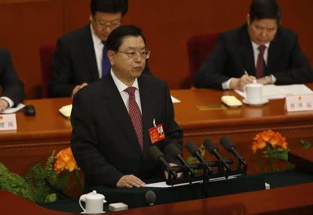 Chairman of the Standing Committee of the National People's Congress (NPC) Zhang Dejiang delivers a work report during a plenary session of the NPC at the Great Hall of the People in Beijing, March 9, 2014. REUTERS/Kim Kyung-Hoon