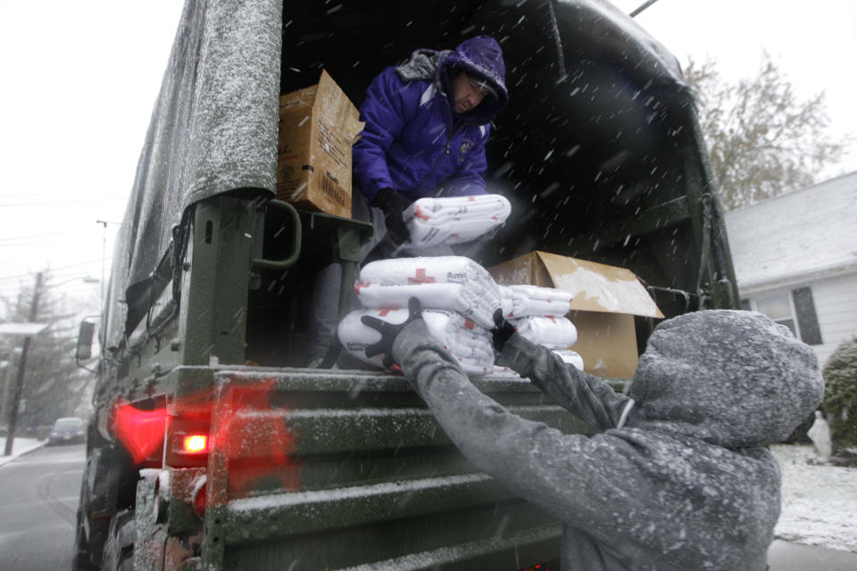 Volunteers Chris Braitsch, left, Karina Ayubi unload blankets donated by the American Red Cross as a Nor'easter approaches in the wake of Superstorm Sandy, Wednesday, Nov. 7, 2012, in Little Ferry, N.J., a town that was flooded during the storm and where some residents were still without power. (AP Photo/Kathy Willens)