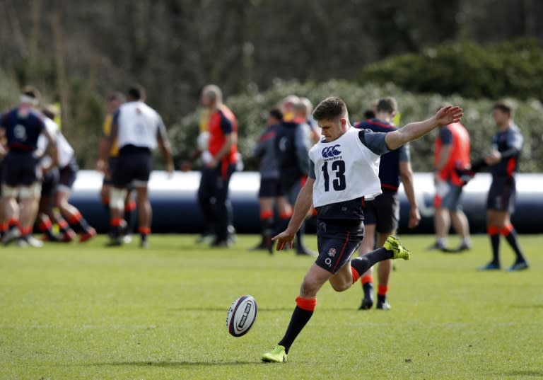 England's centre Owen Farrell prepares to kick the ball during a team training session west of London