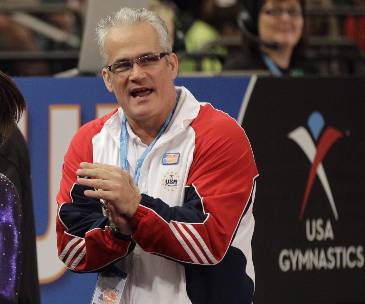 In this March 3, 2012, file photo, gymnastics coach John Geddert is seen at the American Cup gymnastics meet at Madison Square Garden in New York. Prosecutors in Michigan filed charges Thursday, Feb. 25, 2021, against Geddert, a former U.S. Olympics gymnastics coach with ties to disgraced sports doctor Larry Nassar. Geddert was head coach of the 2012 U.S. women's Olympic gymnastics team, which won a gold medal.