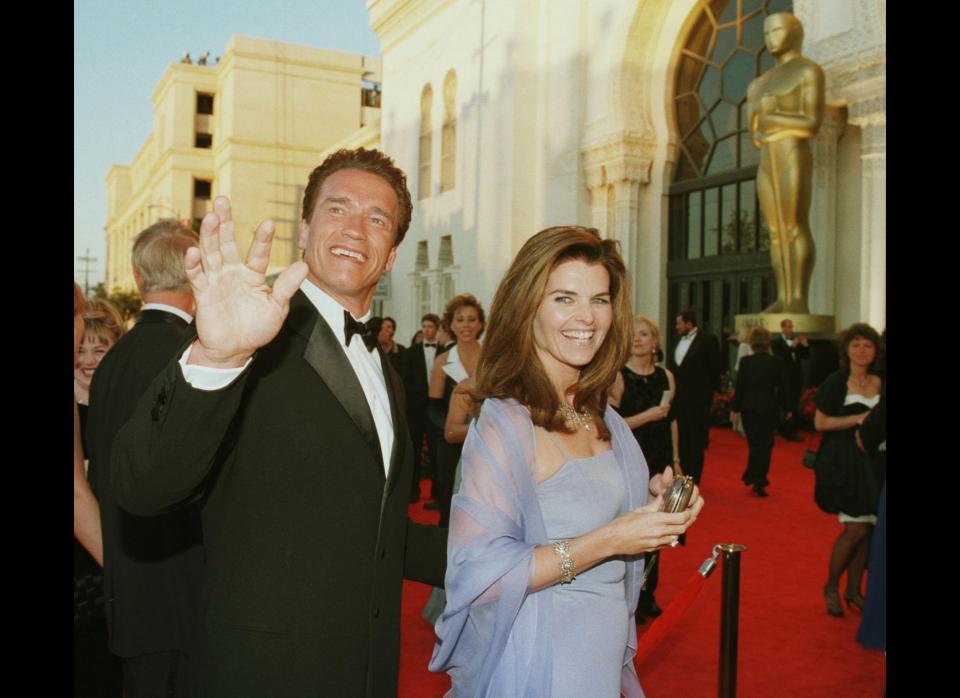 Actor Arnold Schwarzenegger (L) and his wife reporter Maria Shriver (R) arrive for the 70th Annual Academy Awards 23 March in Los Angeles, CA. (HECTOR MATA/AFP/Getty Images/March 24, 1998) 