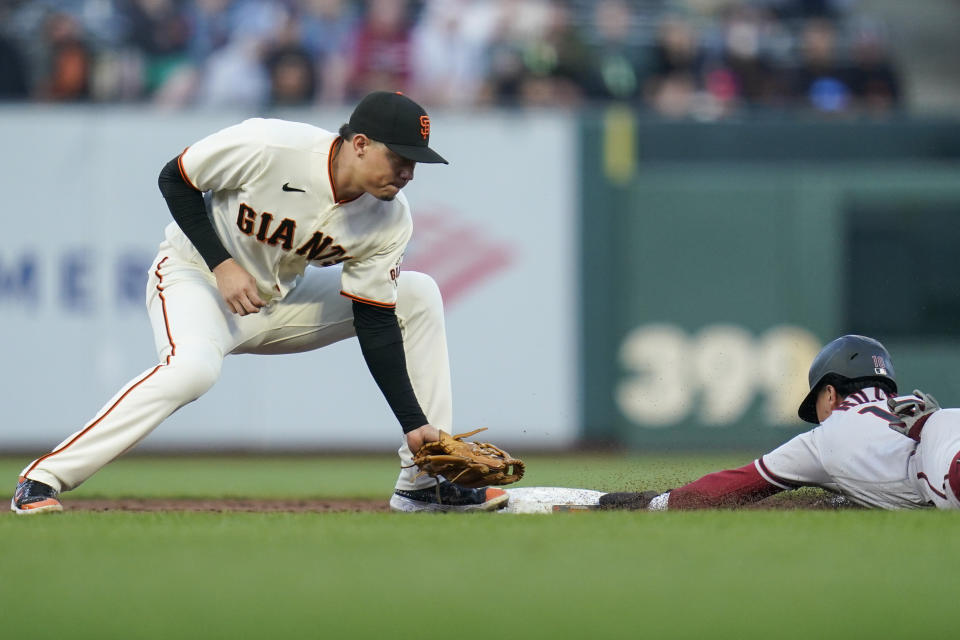 Arizona Diamondbacks' Josh Rojas (10) steals second against San Francisco Giants second baseman Wilmer Flores during the third inning of a baseball game in San Francisco, Monday, Aug. 15, 2022. (AP Photo/Godofredo A. Vásquez)