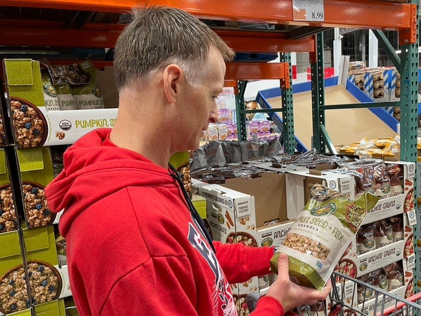 Hilary's husband looking at a package of Pumpkin Seed + Flax granola.