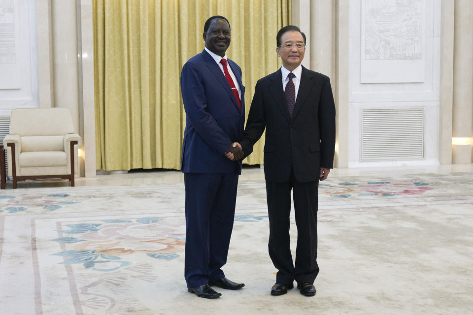 Chinese Premier Wen Jiabao, right, shakes hands with Kenyan Prime Minister Raila Odinga during their meeting at the Great Hall of the People in Beijing, China, Wednesday, July 18, 2012. (AP Photo/Alexander F. Yuan, Pool)