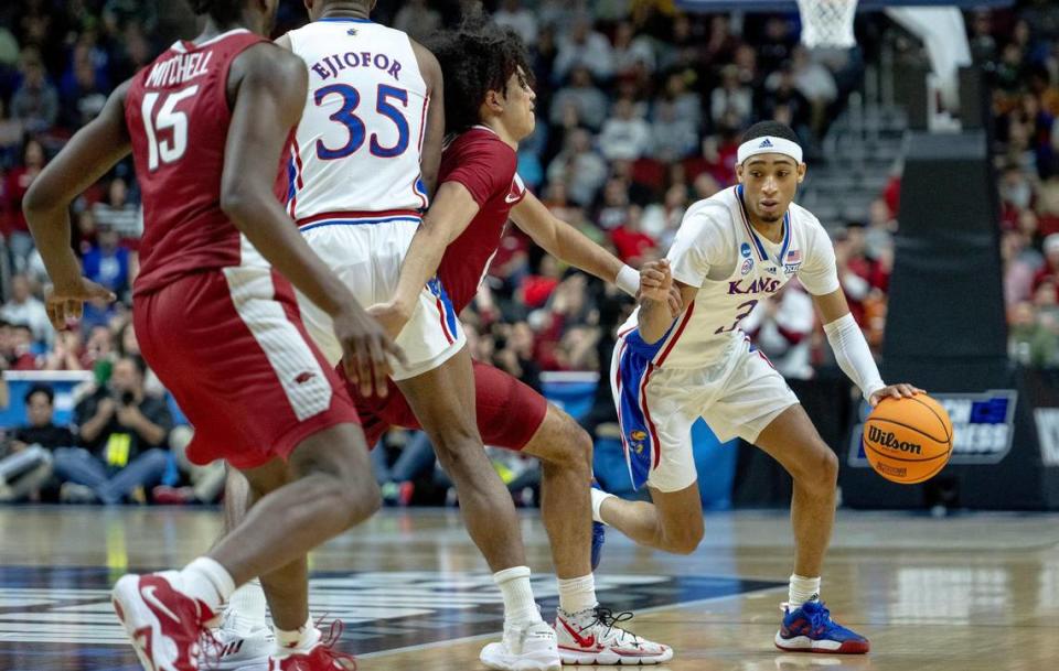 Kansas guard Dajuan Harris Jr. (3) dribbles the ball as forward Zuby Ejiofor (35) sets a screen on Arkansas guard Anthony Black (0) during a second-round college basketball game in the NCAA Tournament Saturday, March 18, 2023, in Des Moines, Iowa.