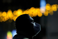 In this photo taken on Saturday, Dec. 26, 2020 a man wearing a mask against the coronavirus, looks at a screen before the arrival of the first batch of COVID-19 vaccines at the National Center for Storage of the COVID-19 Vaccine, a military run facility, in Bucharest, Romania. Across the Balkans and the rest of the nations in the southeastern corner of Europe, a vaccination campaign against the coronavirus is overshadowed by heated political debates or conspiracy theories that threaten to thwart the process. In countries like the Czech Republic, Serbia, Bosnia, Romania and Bulgaria, skeptics have ranged from former presidents to top athletes and doctors. Nations that once routinely went through mass inoculations under Communist leaders are deeply split over whether to take the vaccines at all. (AP Photo/Vadim Ghirda)