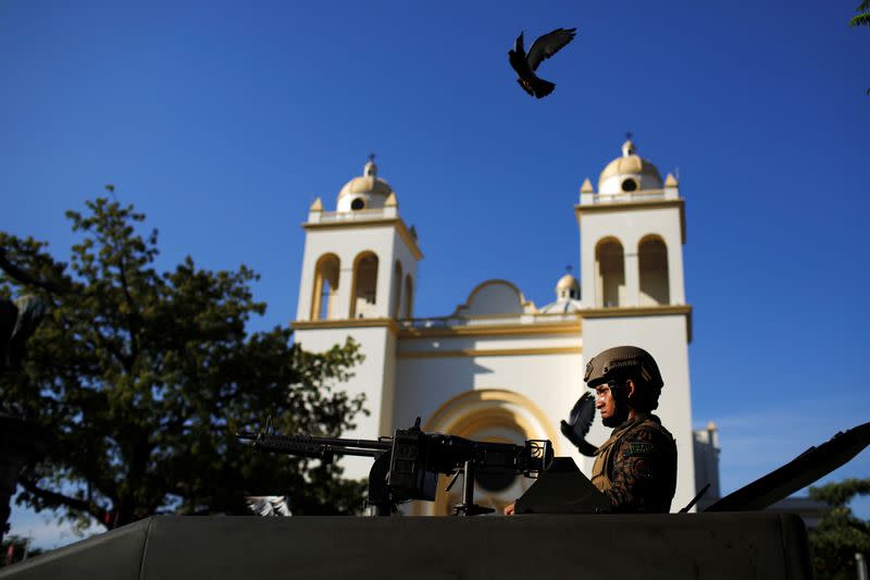 A Salvadoran soldier stands in a combat vehicle before a ceremony to deploy military personnel to support a security plan in San Salvador