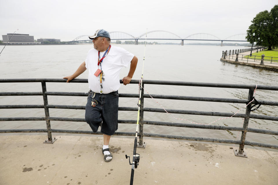 William Roelandt fishes on the Mississippi River, Tuesday, July 16, 2019, in Davenport, Iowa. Hundreds of communities line the Mississippi River, but Davenport is among the few where people can dip their toes into the water without scaling a flood wall or levee. (AP Photo/Charlie Neibergall)