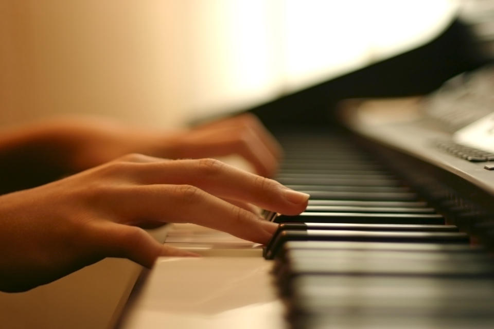 Hands playing the piano