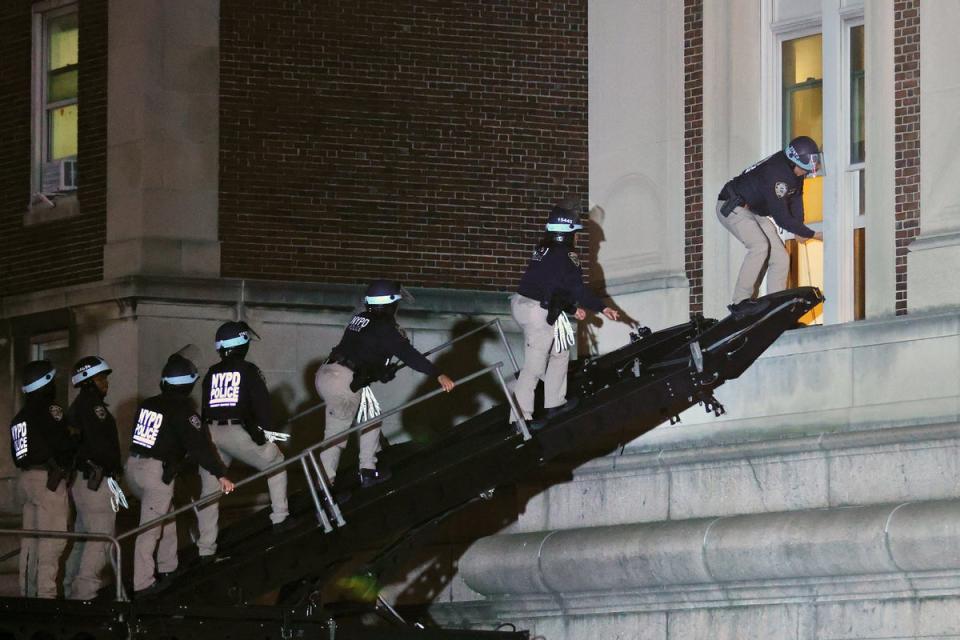 NYPD officers, pictured entered Hamilton Hall on Tuesday night on a “SWAT ramp”, which was occupied by pro-Palestinian protesters. Some journalists are criticising the school for reportedly limiting access to campus during police activity (AFP via Getty Images)