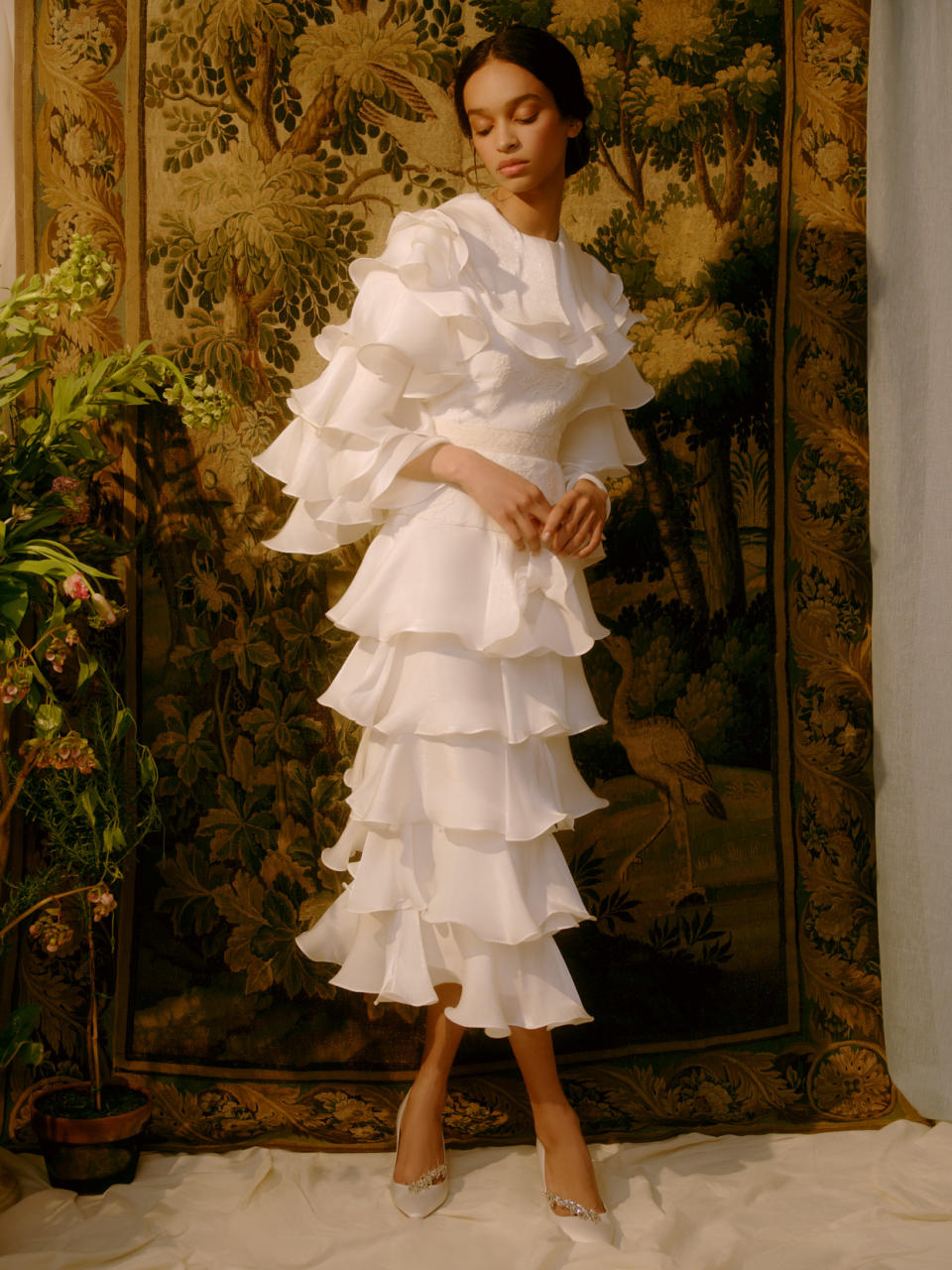 <p>What do you get when you meld Renaissance portraiture and 1950s fashion? <a href="https://markarian-nyc.com/collections/bridal" rel="nofollow noopener" target="_blank" data-ylk="slk:Markarian;elm:context_link;itc:0;sec:content-canvas" class="link ">Markarian</a>'s Spring/Summer 2022 wedding dress collection. Like this mid-length ruffled ensemble, the rest of the series—made with the current celebration climate in mind—feels simultaneously Old-World and fresh.</p>