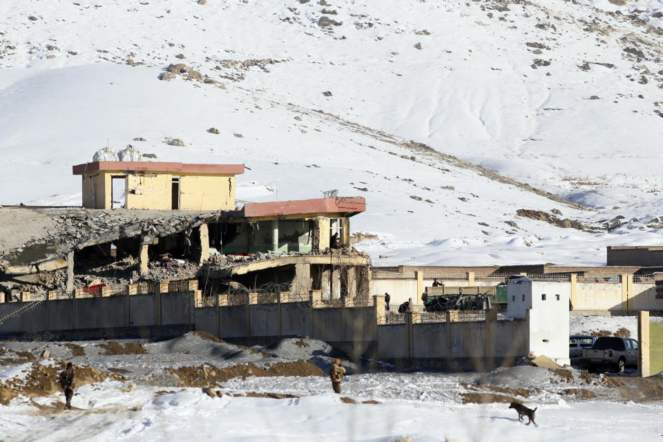 In this Monday, Jan. 21, 2019, photo, Afghan security forces inspect the site of a Taliban attack in Maidan Shar, capital of Maidan Wardak province, east of Kabul, Afghanistan. Afghan official said Tuesday, Jan. 22, 2019, scores of people mostly military personals were killed in the Taliban assault on a military base and a pro-government militia training center a day earlier in the province. (AP Photo)