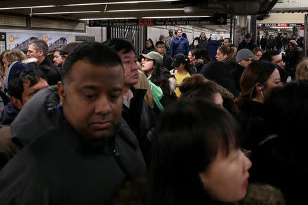 FILE PHOTO: A crowd of New York City subway commuters gather at 34th St - Herald Square station after an explosion near the Port Authority Bus Terminal in Manhattan, New York, U.S., December 11, 2017. REUTERS/Amr Alfiky/File Photo