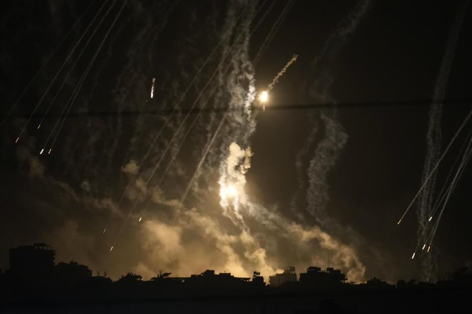FILE - Smoke and flares rise over Gaza City during an Israeli strike in the Gaza Strip, as seen from southern Israel, Friday, Nov. 10, 2023. While journalists' access to the war in Gaza is limited, a flood of video from all sorts of sources documents what is — and isn't — going on. (AP Photo/Leo Correa, File)