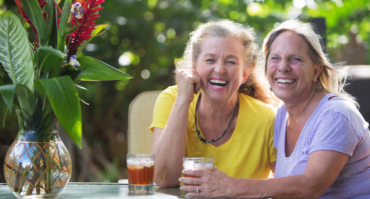 Two women laughing together representing lesbian love