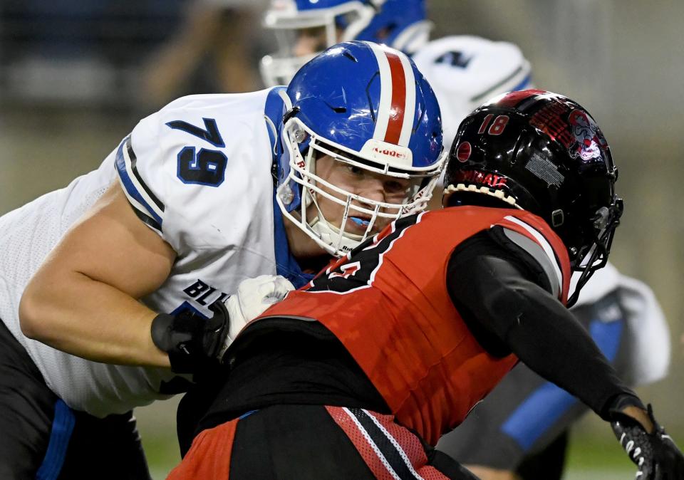 Lake's Anthony Miller blocks McKinley's K'Vuone McNeal in the first half, Friday, Sept 29, 2023.