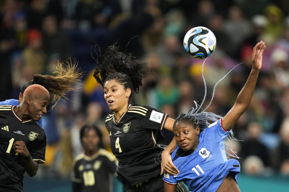 Jamaica's Deneisha Blackwood, left, heads the ball next to teammate Chantelle Swaby, center, and France's Kadidiatou Diani during the Women's World Cup Group F soccer match between France and Jamaica at the Sydney Football Stadium in Sydney, Australia, Sunday, July 23, 2023. The match ended in a 0-0 draw. (AP Photo/Rick Rycroft)