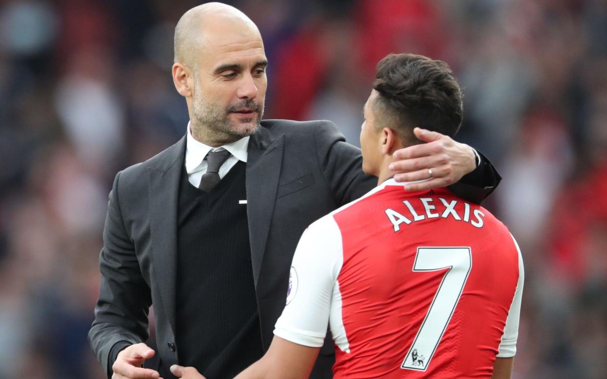 Pep Guardiola (left), the Manchester City manager, is understood to have instructed his club to make a bid of around £60 million to Arsenal for their Chile international Alexis Sánchez - Rex Features