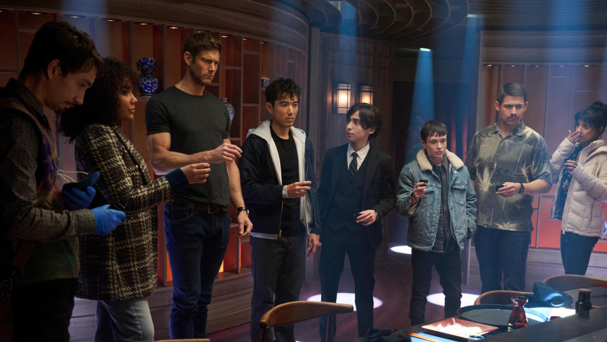  The Hargreeves family gather around for an alcoholic shot in The Umbrella Academy season 4 on Netflix. 