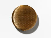 <p>This gold compact with small lines also may have been the first compact ever, and it says New York. The same design was later redone in 1962 and was a bit smaller and the lines go vertically instead of horizontally. Another way to tell them apart is the later one says New York, London, Toronto on it — the brand wasn’t carried at Harrods until 1960. <i>(Photo: Henry Leutwyler)</i></p>