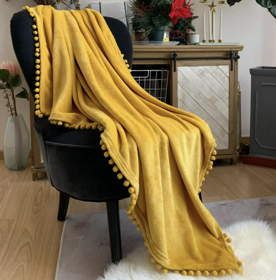 the yellow blanket on accent chair