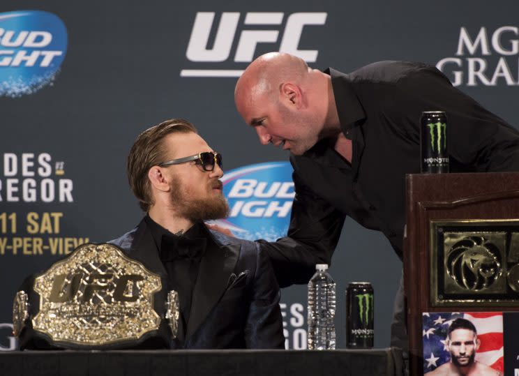 UFC president Dana White (R) chats with Conor McGregor at a news conference. (Getty Images)