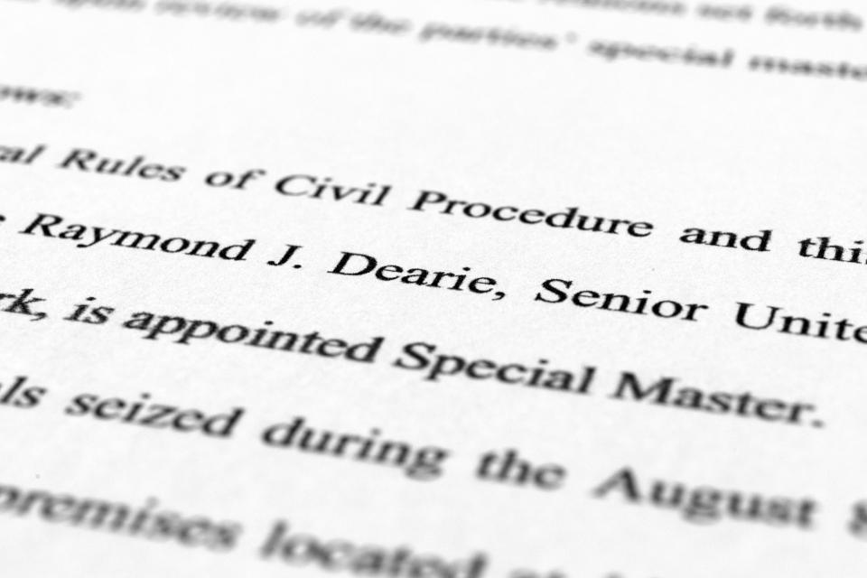 A page from the order by U.S. District Judge Aileen Cannon naming Raymond Dearie as special master to serve as an independent arbiter and to review records seized during the FBI search of former President Donald Trump's Mar-a-Lago estate, is photographed Thursday, Sept. 15, 2022. (AP Photo/Jon Elswick) ORG XMIT: DCJE394