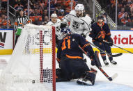 Los Angeles Kings' Phillip Danault (24) scores a goal on Edmonton Oilers goalie Mike Smith (41) during the third period of Game 1 of an NHL hockey Stanley Cup first-round playoff series, Monday, May 2, 2022 in Edmonton, Alberta. (Jason Franson/The Canadian Press via AP)