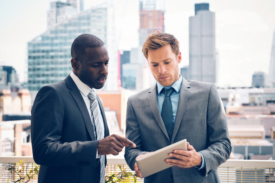 Business people looking at a tablet.