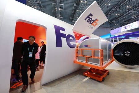 People visit a FedEx Express booth during the China International Import Expo (CIIE) in Shanghai