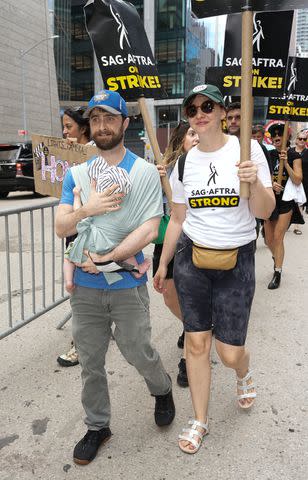 <p>John Nacion/Getty </p> Daniel Radcliffe and Erin Darke join the picket line In New York City on July 21, 2023 in New York City