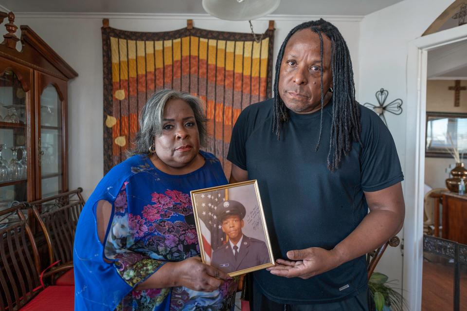 Patti Pugh, left, and Kennedy Pugh hold a photograph of their late brother U.S. Air Force veteran Alvin J. Pugh at their home on Saturday, March 30, 2024.