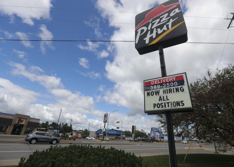 A sign advertising job openings is seen on Wednesday at Pizza Hut on Central Avenue in Marshfield.