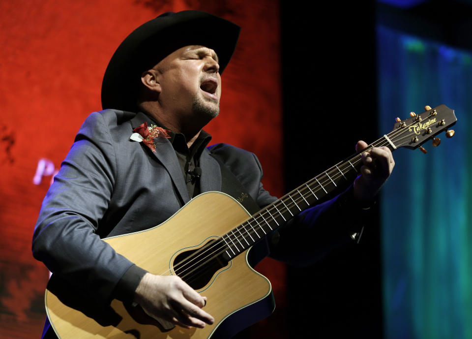 Garth Brooks sings "Papa Loved Mama," a song written by Kim Williams, as Williams is inducted into the Nashville Songwriters Hall of Fame on Sunday, Oct. 7, 2012, in Nashville, Tenn. (AP Photo/Mark Humphrey)